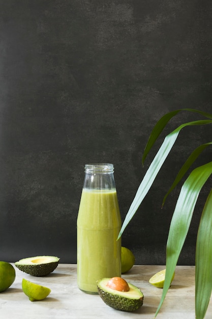 Photo high angle bottle with avocado smoothie