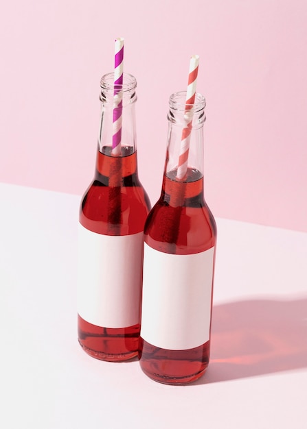 Photo high angle bottles with straws