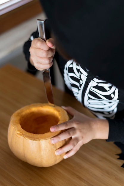 High angle of boy with pumpkin concept