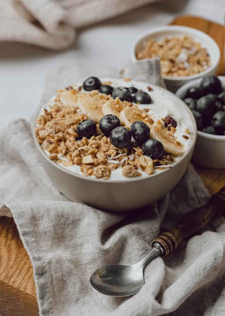 High angle of breakfast in bed with blueberries and cereal