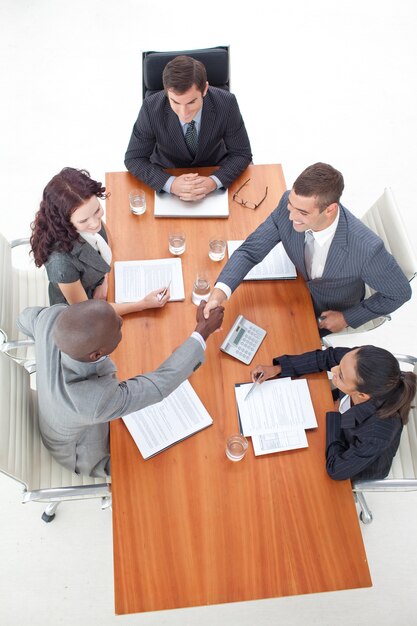 High angle of businessmen shaking hands in a meeting