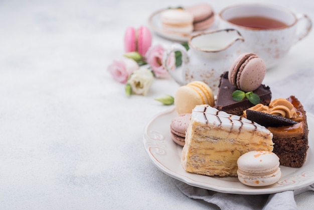 Photo high angle of cake on plate with macarons and copy space