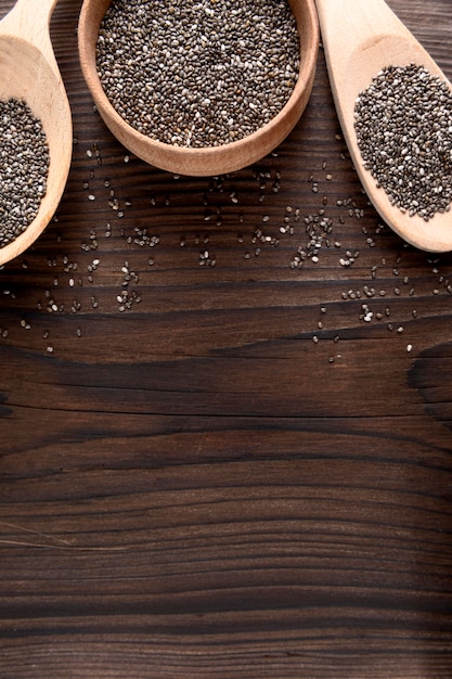 High angle of chia seeds in wooden spoon