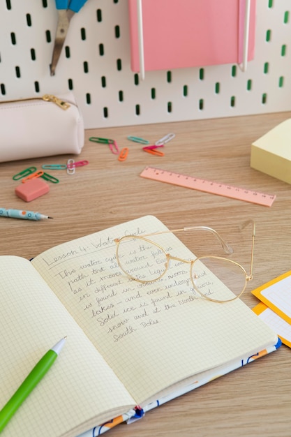 Photo high angle of children's desk with notebook and pens