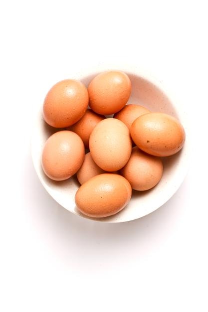 High angle close-up view of eggs in a white bowl