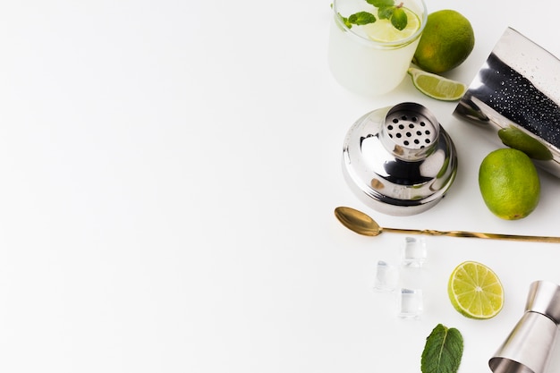 High angle of cocktail essentials with lime and copy space