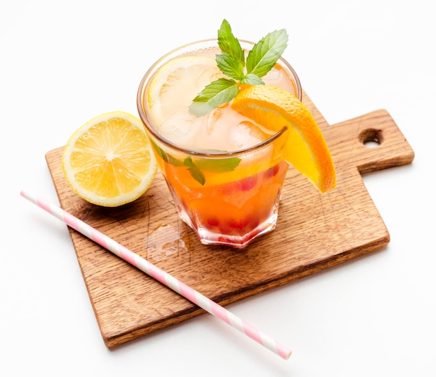 High angle cocktail with orange on cutting board and copy-space