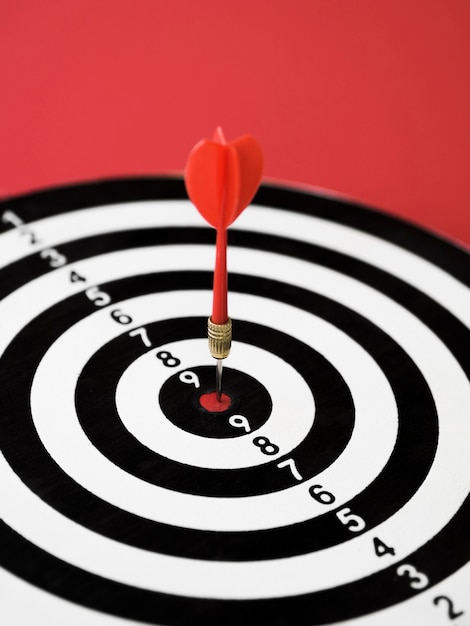 High angle of dart board with dart on bull's-eye