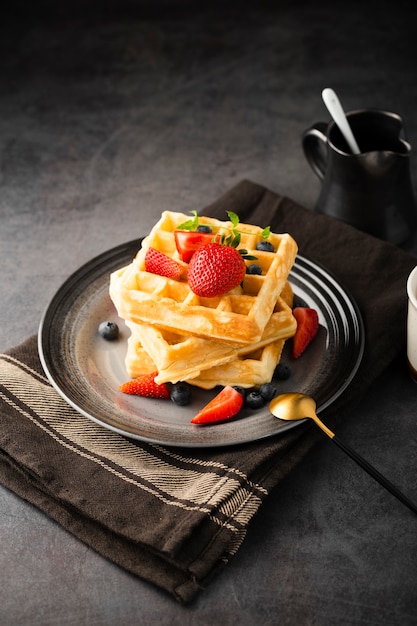 High angle delicious waffles with fruits