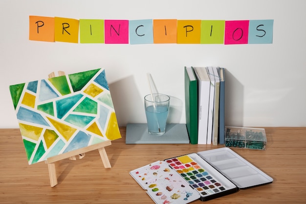 Photo high angle desk arrangement with painting