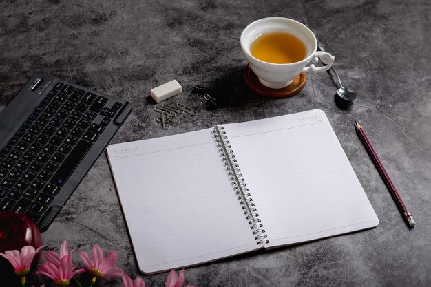 High angle desk with hot tea and keyboard for working