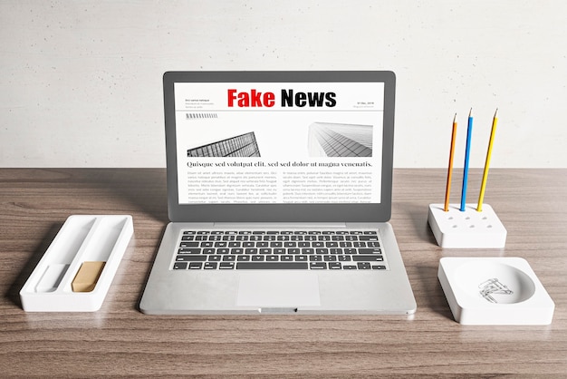 Photo high angle of desk with laptop and fake news