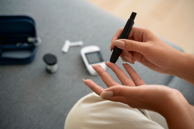 High angle diabetic woman checking her glucose level