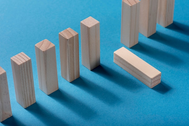 High angle of domino pieces with one fallen down