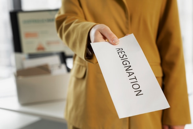 Photo high angle employee holding resignation note