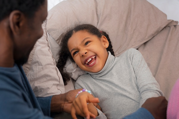 High angle father tickling girl