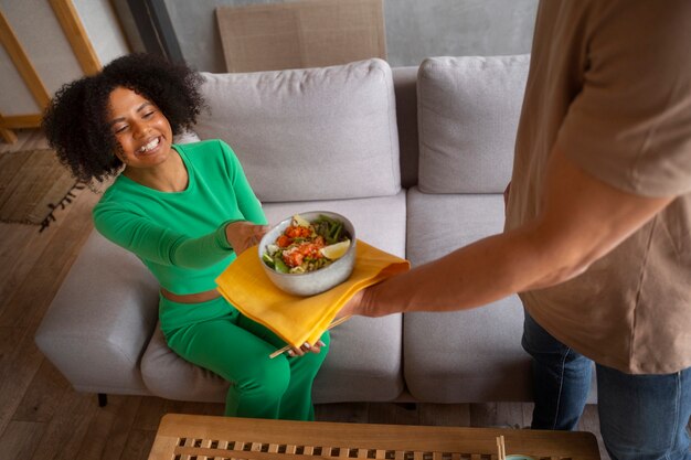 High angle friends eating salmon bowl