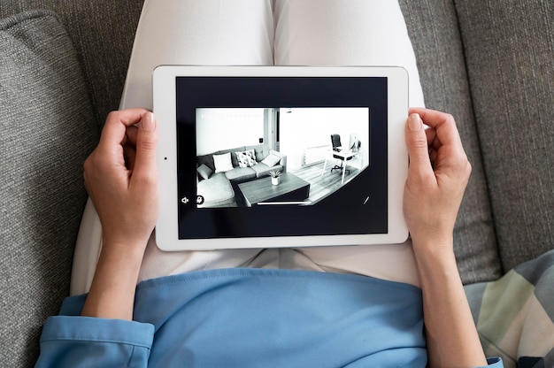 High angle hands holding tablet