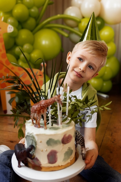 High angle kid holding cake