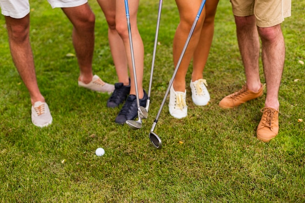 High angle legs of golfers with clubs