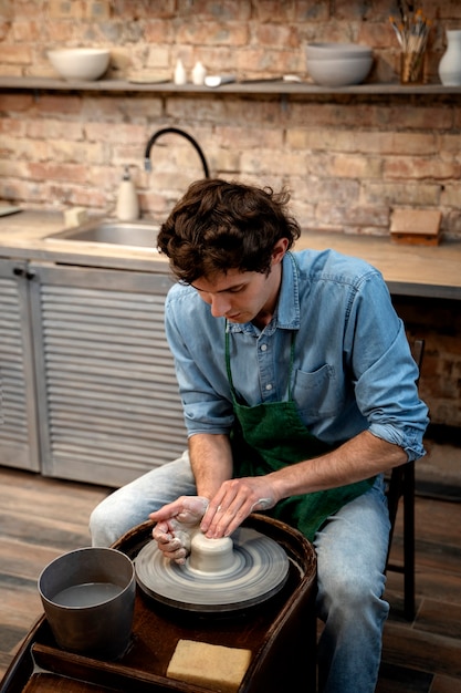 High angle man doing pottery