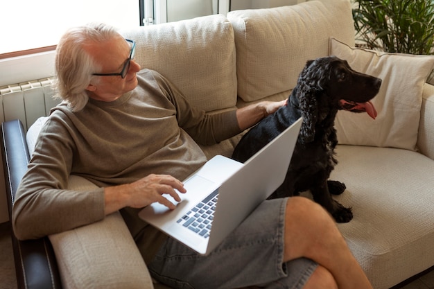 High angle old man petting dog