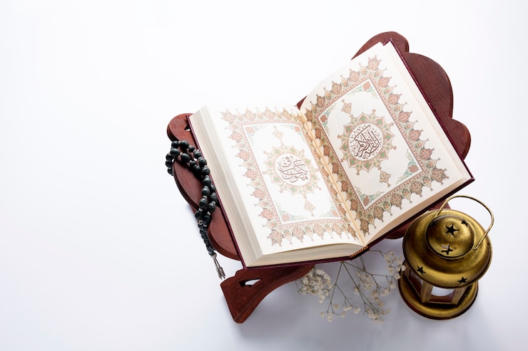 Photo high angle opened quran next to candle 