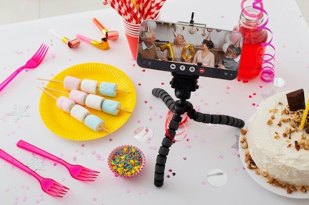 Photo high angle party items and smartphone arrangement