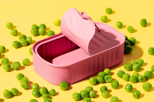 High angle pink tin can with peas