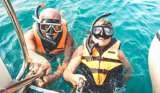 High angle portrait of couple snorkeling in sea