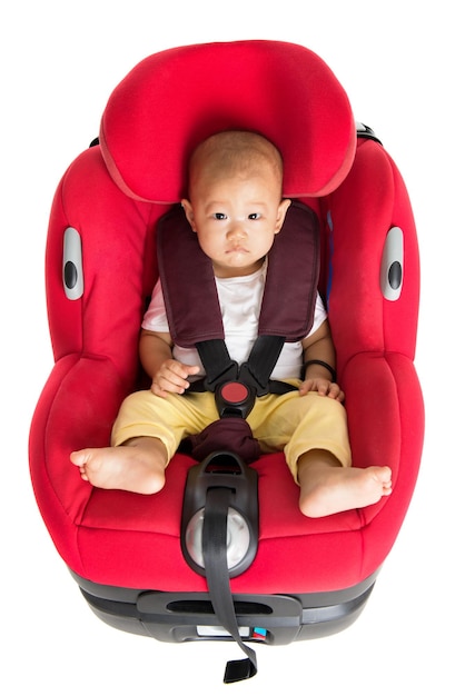 High angle portrait of cute baby boy sitting in car seat against white background