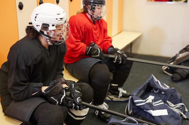 High angle portrait of female hockey players in locker room