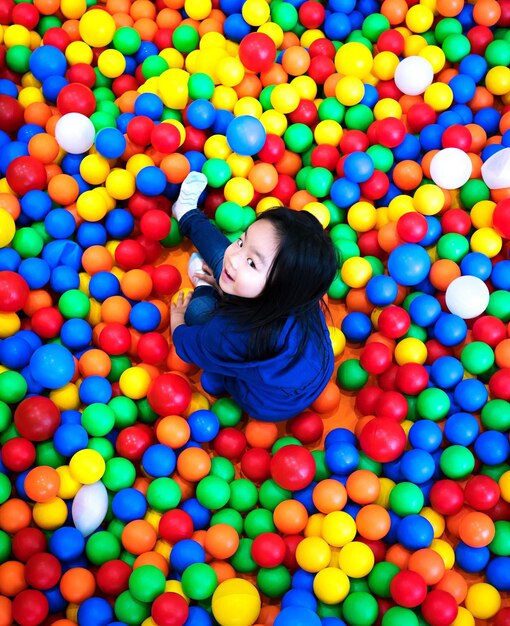 High angle portrait of girl playing in ball pool