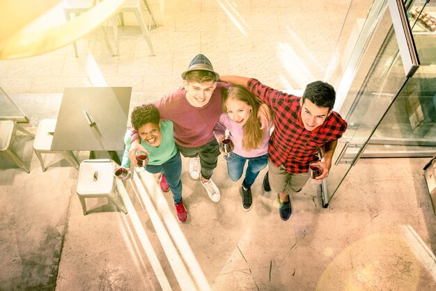 High angle portrait of smiling friends walking from restaurant