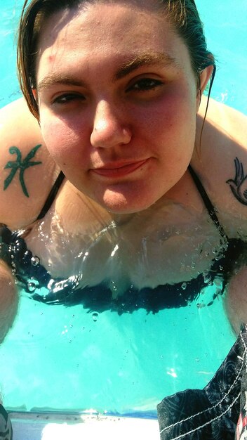 High angle portrait of woman swimming in pool