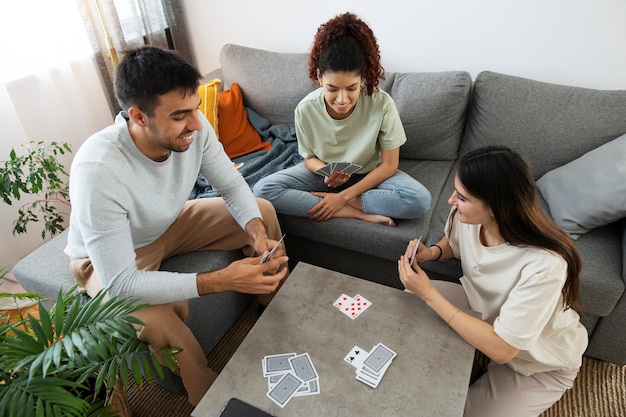 Foto compagni di stanza ad alto angolo che giocano a carte