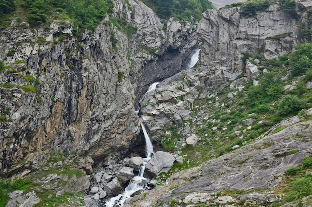 High angle shot of a mountainous landscape with a small waterfall