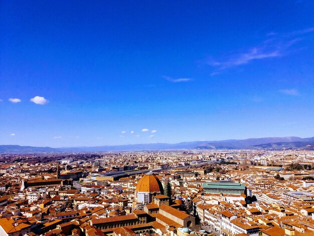 High angle shot of townscape against blue sky