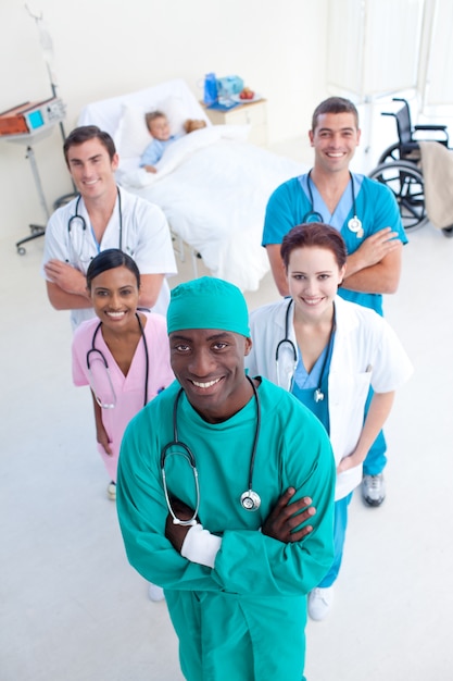 High angle of smling medical team with a child patient