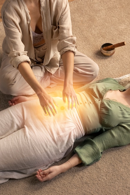 High angle therapist helping woman