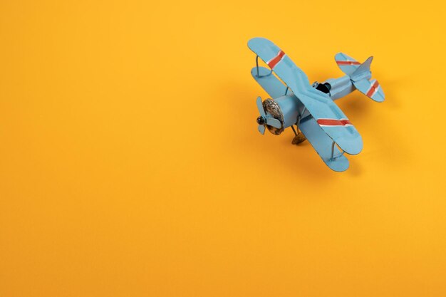 High angle view of airplane flying against orange background