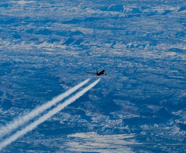 High angle view of airplane flying in sky