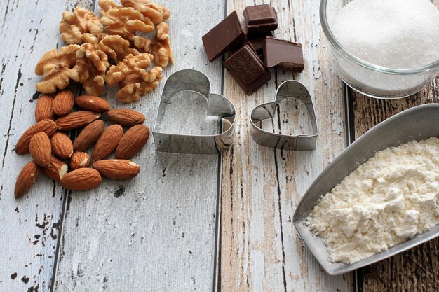 Photo high angle view of almonds with chocolates and pastry cutters on table