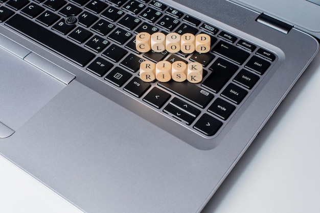 Photo high angle view of alphabets in wooden blocks on laptop keyboard