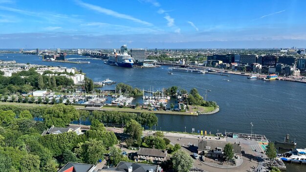 Photo a high angle view of amsterdam by the ij river taken from the adam tower in amsterdam noord