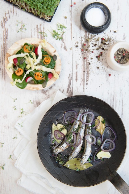 High angle view of anchovies in cooking pan on table