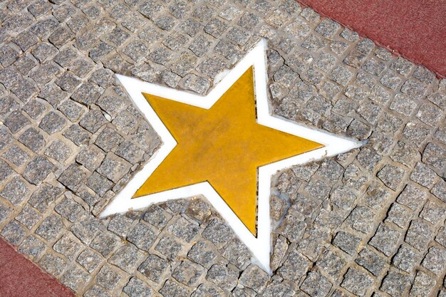 High angle view of arrow sign on footpath