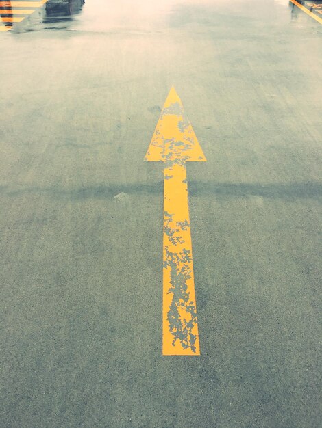 High angle view of arrow sign on road