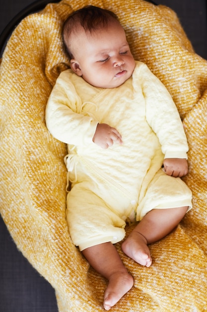 High angle view of baby girl sleeping in the bed