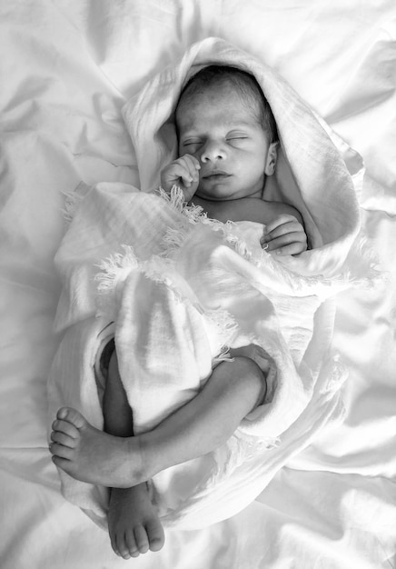 High angle view of baby sleeping on bed